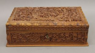 An Indian carved wooden box. 29 cm wide.