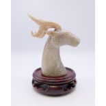 A Chinese white jade stags head, with modern wooden stand, Han Dynasty. The former 7.5 cm high.