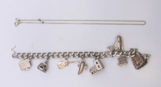 A silver charm bracelet and a chain. Charm bracelet 19 cm long. 78.1 grammes total weight.