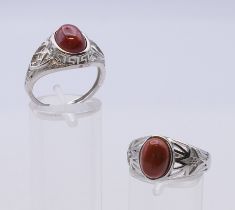 Two adjustable silver dress rings.