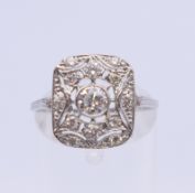 An 18 ct white gold diamond Art Deco style cluster ring. Ring size N. 3.3 grammes total weight.