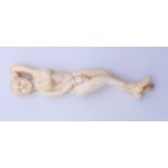 A bone medical figure. 13 cm long.