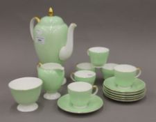 A Wedgwood gilt heightened green and white tea set. The teapot 23.5 cm high.