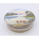 A silver and enamel pill box decorated with cattle in a mountainous landscape,