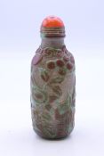 A Chinese overlay glass snuff bottle. 9 cm high.