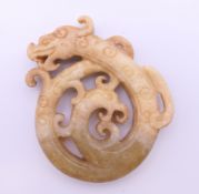 A Chinese white jade dragon pendant, Han Dynasty. 6 cm high.