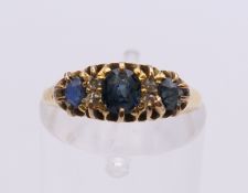 An 18 ct gold sapphire and diamond ring. Ring size J/K. 2.6 grammes total weight.