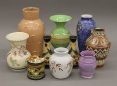A collection of various Art Deco vases, including Carlton Ware. The largest 27 cm high.