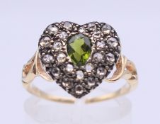 An unmarked 18 ct gold heart shaped cluster ring. Ring size N/O. 3 grammes total weight.