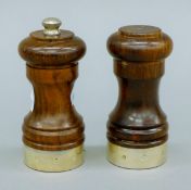 A pair of silver mounted wooden salt and peppers. The pepper 10 cm high.