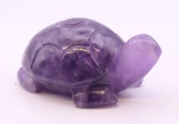 A carved amethyst model of a tortoise. 4.5 cm x 7 cm.