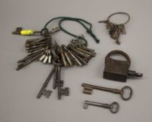 A collection of antique keys and a lock.