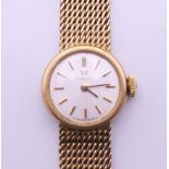 A ladies 9 ct gold Omega wristwatch. 1.75 cm wide. 20.8 grammes total weight.