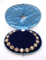 A Georgian seed pearl and cameo necklace in associated Garrard's box. Approximately 36 cm long.