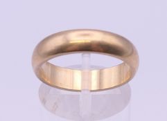 A 9 ct gold wedding band. Ring size Q/R. 5.1 grammes.