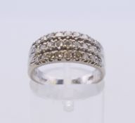 A white gold three row diamond ring. Ring size N. 4 grammes total weight.