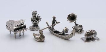 A small quantity of white metal miniature ornaments formed as: a rabbit, a bagpiper, a swan,