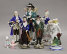 A collection of porcelain figurines, including two pairs of Sitzendorf figures. The largest 23.