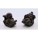 A pair of bronze models of pigs on rocking chairs. Each 4 cm high.