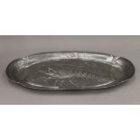 A large pewter Art Nouveau lobster dish decorated with a lobster surrounded by small fish,