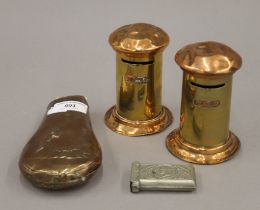 Two brass and copper money boxes, a shot flask and a vesta. The former each 10.5 cm high.