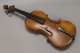 A violin with label dated 1924. 59 cm long.