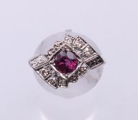 A 14 K white gold ruby and diamond dress ring. Ring size K. 4.1 grammes total weight.