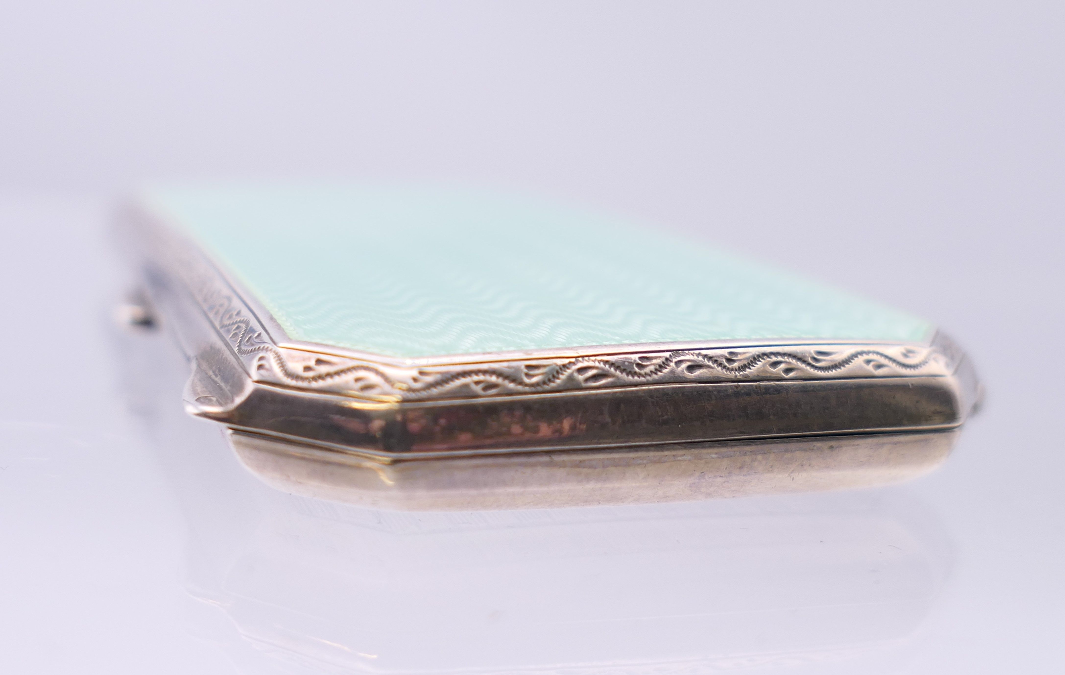 An early 20th century enamel decorated silver cigarette case. 8 cm x 4.5 cm. - Image 9 of 9