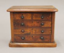 A money box formed as a Victorian chest of drawers. 12.5 cm wide.