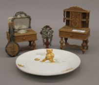 A small quantity of dolls house furniture and a child's plate. The dresser 14 cm high.