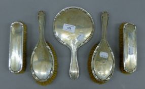 A five piece silver brush and mirror set, hallmarked Birmingham 1924,