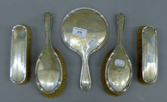 A five piece silver brush and mirror set, hallmarked Birmingham 1924,