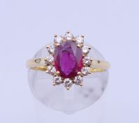 An 18 ct gold ruby and diamond cluster ring. Ruby weight approximately 1.