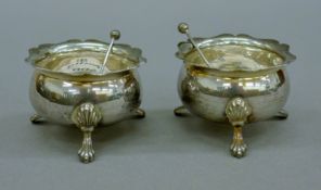 A pair of silver salts with associated silver salt spoons. 5.5 cm diameter. 76.5 grammes.