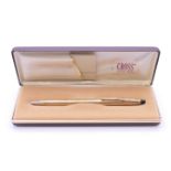 A boxed Cross ballpoint pen.