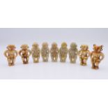 Nine Chinese fertility beads (seven male and two female), Han Dynasty. Each approximately 4 cm high.