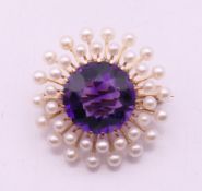 An unmarked gold amethyst and pearl brooch. 2.5 cm diameter. 5.5 grammes total weight.