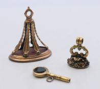 Two 19th century unmarked fob seals and a fob seal/watch key. Largest 4.5 cm high.
