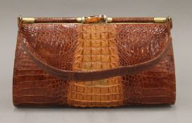 A crocodile skin handbag. 27.5 cm wide.