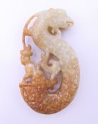 A Chinese man riding a mythical creature form pendant, Han Dynasty. 7.5 cm high.