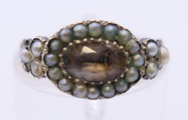 An antique unmarked gold seed pearl and gemstone ring. Ring size I/J. 1.7 grammes total weight.