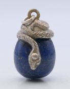 A lapis form egg pendant set with a snake. 2.5 cm high.