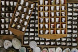 A large collection of thimbles and pill boxes, including Limoge.
