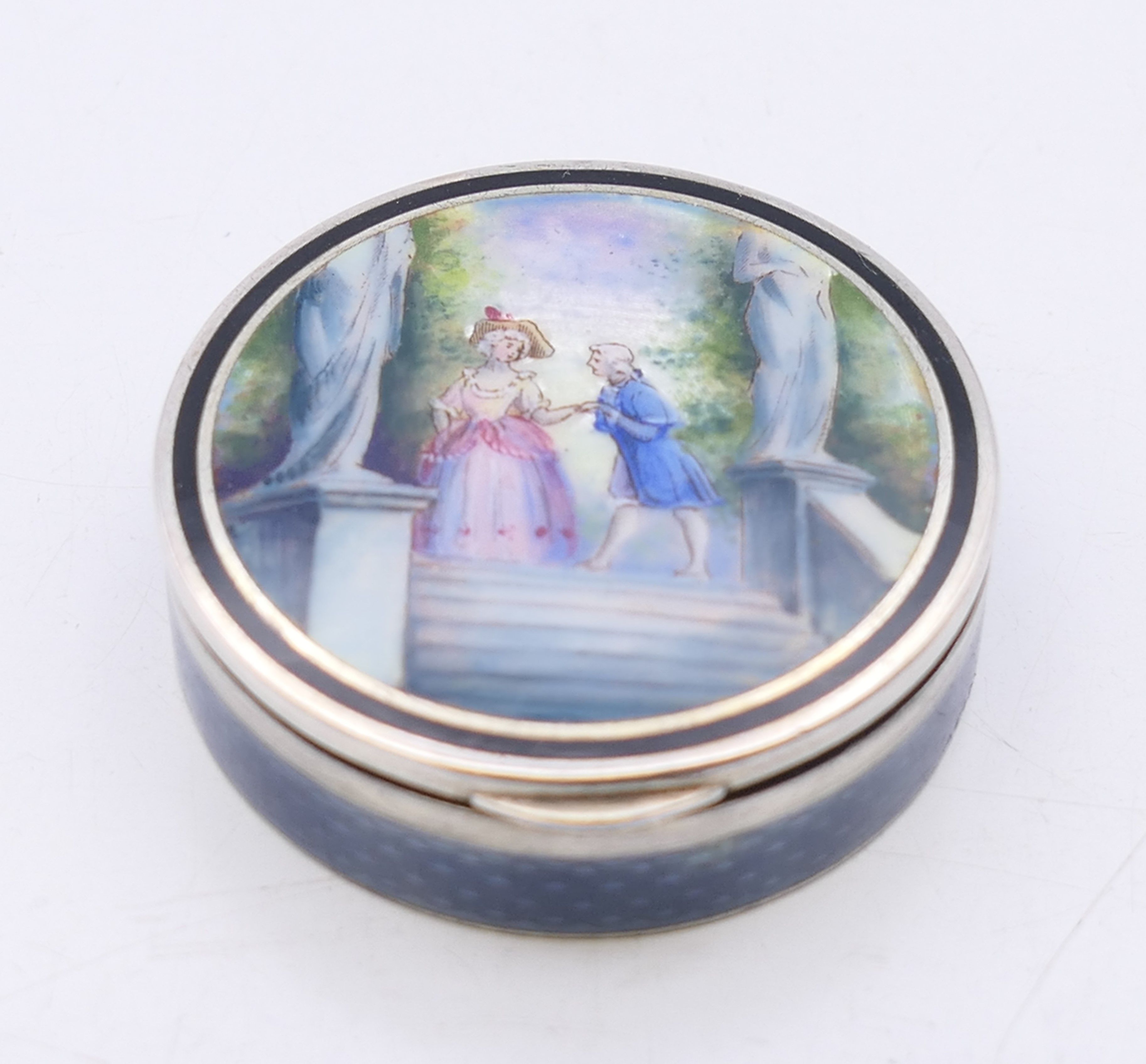 A late 19th/early 20th century French silver and enamel pill box,