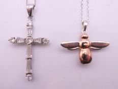 Two silver pendants on silver chains. The largest pendant 3.5 cm high.