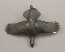 A bronze car mascot formed as a red grouse. 11.5 cm wide.