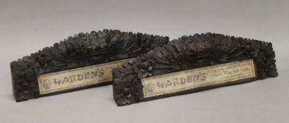A pair of carved Harden's Tea adverts. The largest 36 cm long.