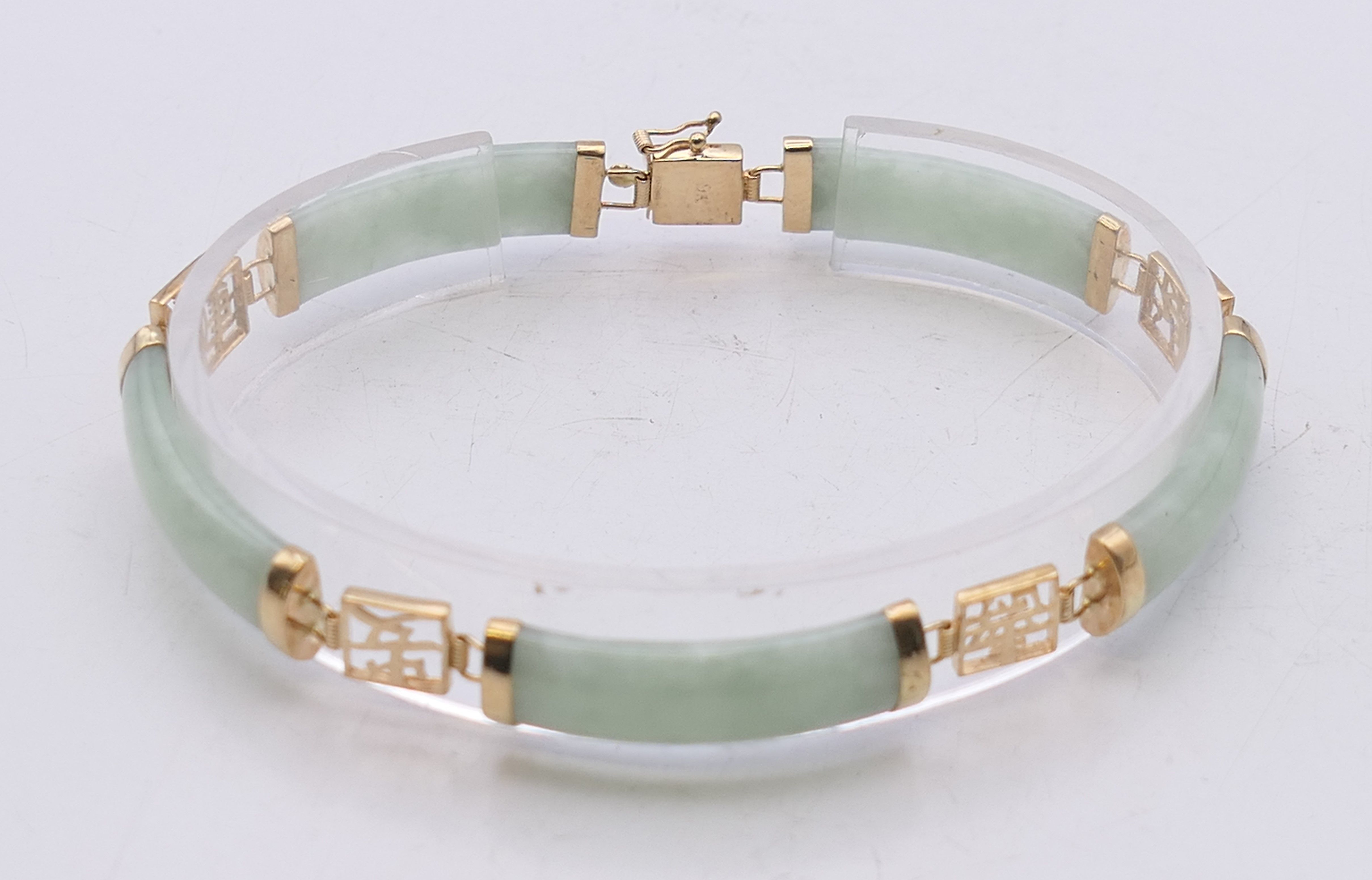 A small Chinese jade bracelet set with 9 ct gold. 19 cm long.