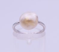 A platinum and natural pearl ring, circa 1920. Ring size G/H. 3.2 grammes total weight.