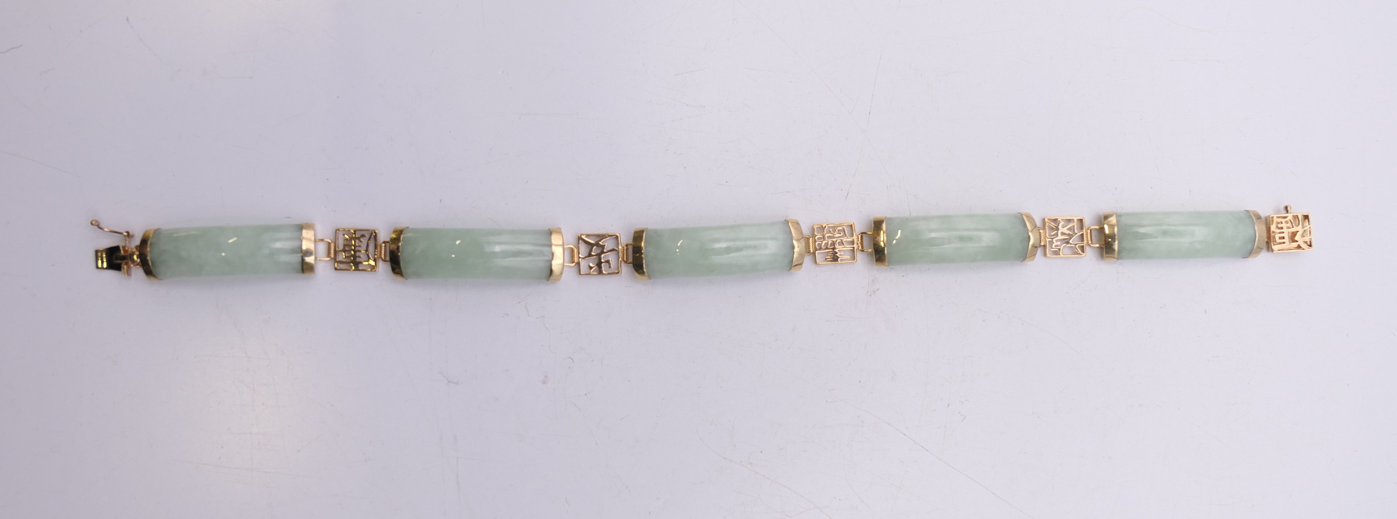 A small Chinese jade bracelet set with 9 ct gold. 19 cm long. - Image 6 of 6